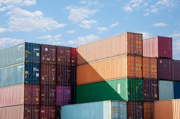 Container stockyard in sunlight Rows of stacked shipping containers under a blue sky
